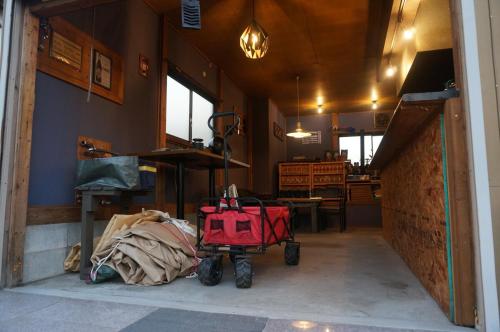 a room with a red luggage cart in a house at KAMADOBA glamping in Tōganemachi