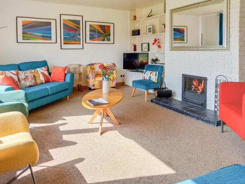 a living room with a couch and a fireplace at Beech House in Torcastle