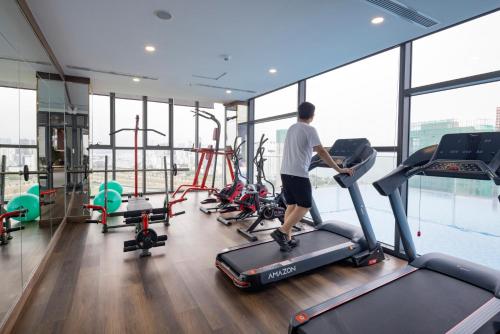 a man exercising on a treadmill in a gym at Miracle Luxury Nha Trang in Nha Trang