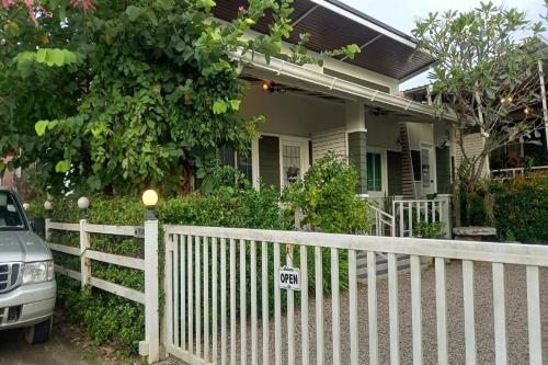 a white fence in front of a house at Bann Kam B&B in Krabi town