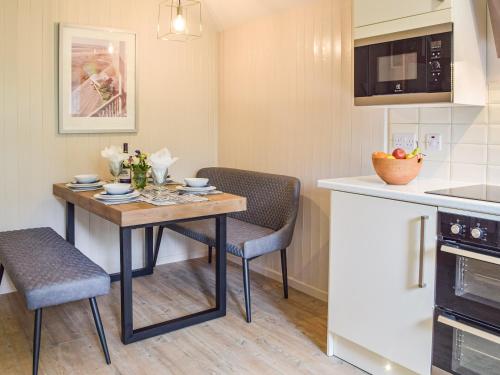 a small kitchen with a table and two chairs at Mutton Hill Cottage in Pembroke