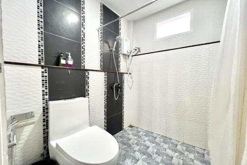 a bathroom with a toilet and a shower at Bann Kam B&B in Krabi town