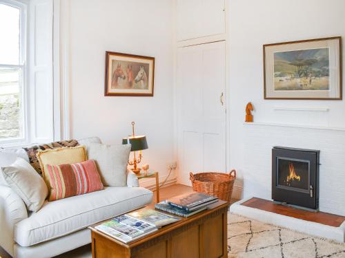 a living room with a couch and a fireplace at West Lodge in Barnard Castle