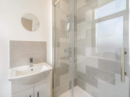 a white bathroom with a sink and a shower at Apartment Four - Uk44287 in Arbroath