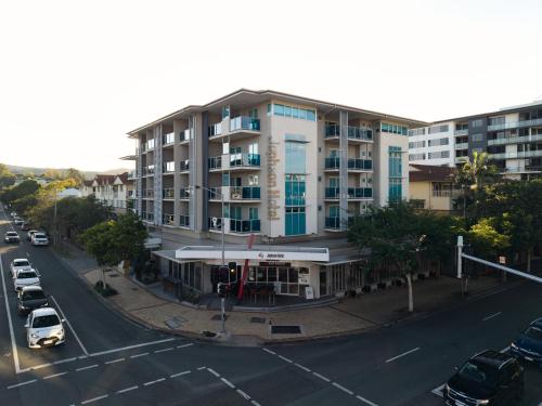 an apartment building on a city street with a parking lot at Jephson Hotel & Apartments in Brisbane