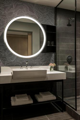 a bathroom with a sink and a mirror at Kimpton Sawyer Hotel by IHG in Sacramento