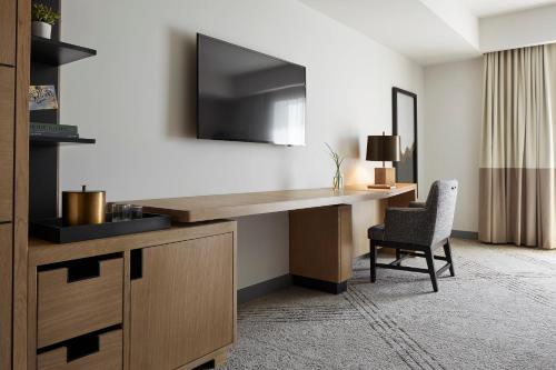 a desk in a hotel room with a chair at Kimpton Sawyer Hotel by IHG in Sacramento