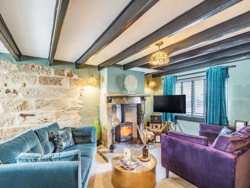 a living room with two couches and a fireplace at The Twisted Toad in Guisborough