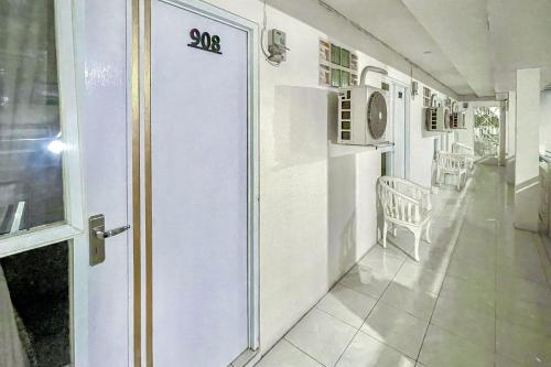 a white room with a door with the number on it at Urbanview Syariah Oemah Isun Homestay Cirebon by RedDoorz in Tangkil