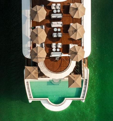 an overhead view of a cruise ship with umbrellas at Bhaya Soul - Wellness Inclusive Cruise in Ha Long