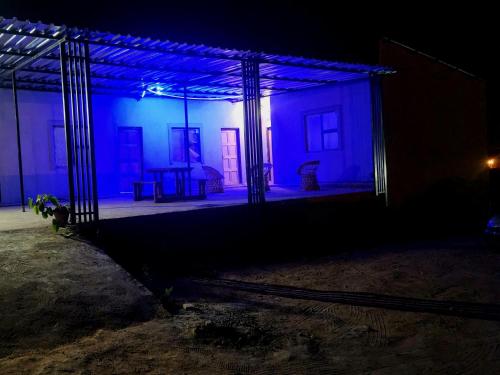 a dark room with blue lights on a building at GenAyah Hotel & Safari in Mtimba