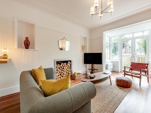 a living room with a couch and a fireplace at Number 3 in Bournemouth