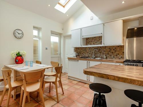 a kitchen with a table and chairs in a kitchen at Number 3 in Bournemouth