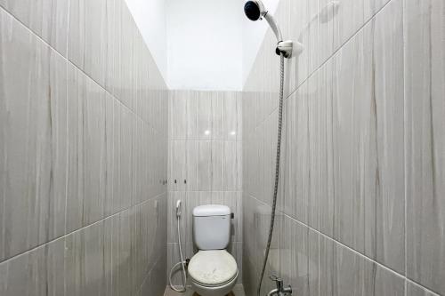 a bathroom with a shower with a toilet in it at Urbanview Syariah Oemah Isun Homestay Cirebon by RedDoorz in Tangkil