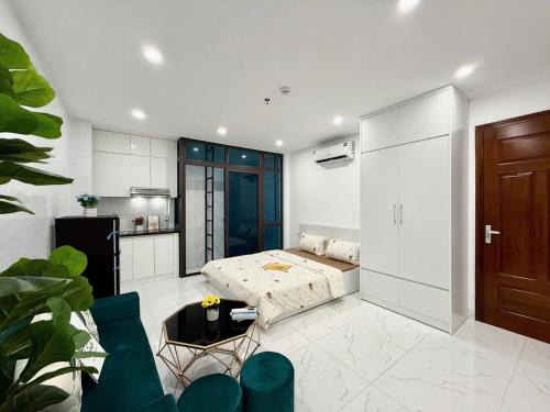 a living room with a bed and a kitchen at Hea Home in Hanoi