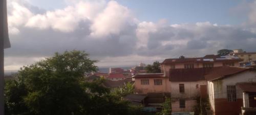 a group of houses in a city under a cloudy sky at Comfort Zone Furnished Apartments 2 in Freetown