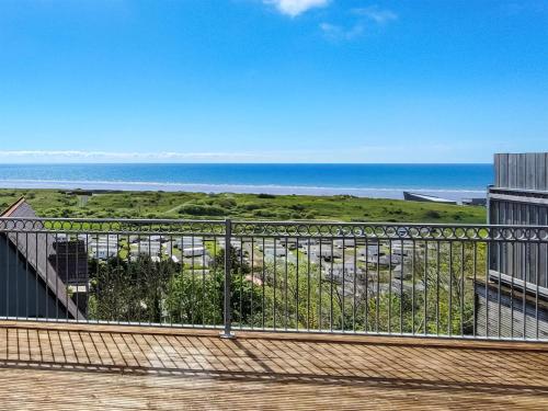 a view of the ocean from the balcony of a building at Pendine Beach Apartment in Pendine