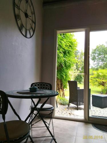 a room with a table and a clock on the wall at Villa Lescala in Blaye