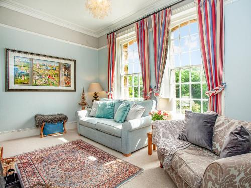a living room with a couch and a chair at Lynwood in Boscastle