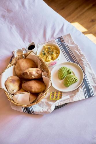 a basket of bread and bowls of food on a table at Maimara Hotel in Huaraz