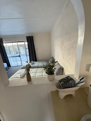 a living room with a mirror and a couch at La Maison in Rotorua