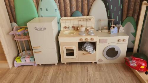a doll house with a play kitchen and a playset at Innspire Hotel by Suntai in Port Dickson