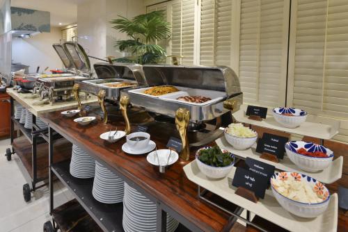 a buffet line with various food items on display at Centre Point Sukhumvit Thong-Lo in Bangkok