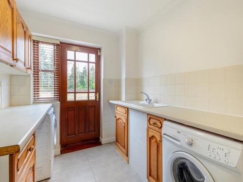 a kitchen with a sink and a washing machine at Stenson Hill Farm in Melbourne