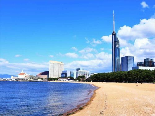 a view of a beach with a city in the background at Tokyu Stay Hakata in Fukuoka