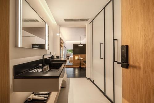 a kitchen with a black counter and a sink at Hill Design Hotel 山丘设计师酒店 春熙路太古里店 in Chengdu
