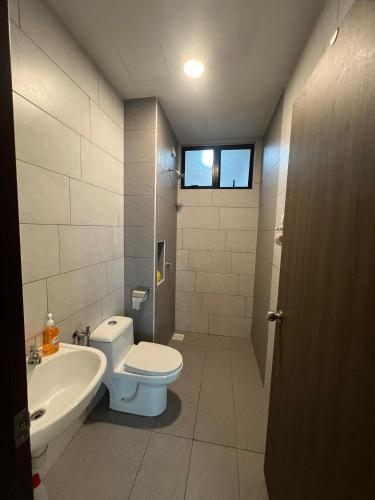 a bathroom with a toilet and a sink at Latte Homestay Desaru 5GWifi with Swimming Pool in Bandar Penawar