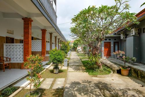a corridor of a house with trees and plants at RedDoorz Plus @ Singaraja in Singaraja