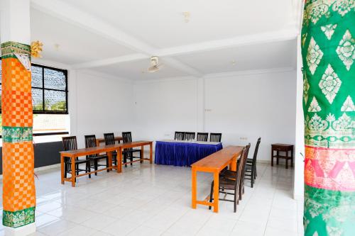 a dining room with wooden tables and chairs at RedDoorz Plus @ Singaraja in Singaraja