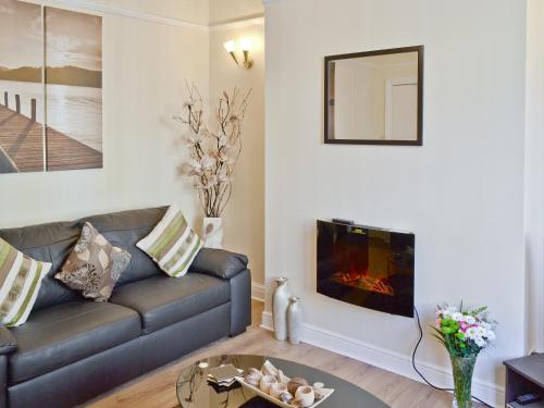 a living room with a couch and a fireplace at Mill View House in Scarborough