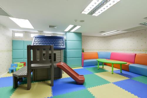 a play room with a slide and a playground at Centre Point Sukhumvit Thong-Lo in Bangkok