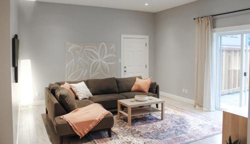 a living room with a couch and a table at Sooke Getaway - Relax & Recharge in Nature, Private 7min to Sooke in Sooke
