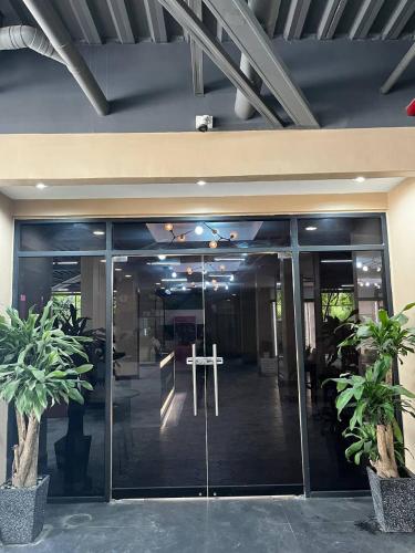 an office building with glass doors and potted plants at Friendship On Hotel Wink in Angeles