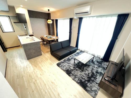 a living room with a couch and a table at ゼクス中浜 in Osaka