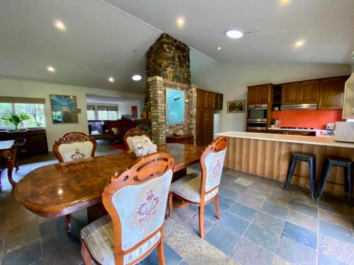a dining room with a wooden table and chairs at Mornington Peninsula Farmhouse in Main Ridge