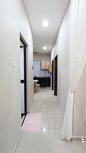 a hallway with white walls and a doorway with a curtain at The Junid Hauz Muar in Muar