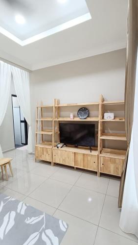 a living room with a wooden entertainment center at The Junid Hauz Muar in Muar