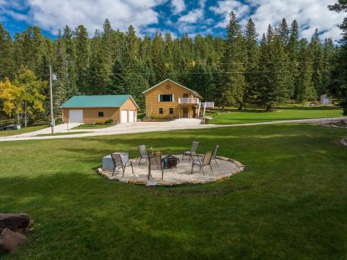 a group of chairs sitting around a fire pit in a yard at Ponderosa Hideaway-ATV, Hiking, Snowmobiling, Hunting & Casino Fun in Deadwood