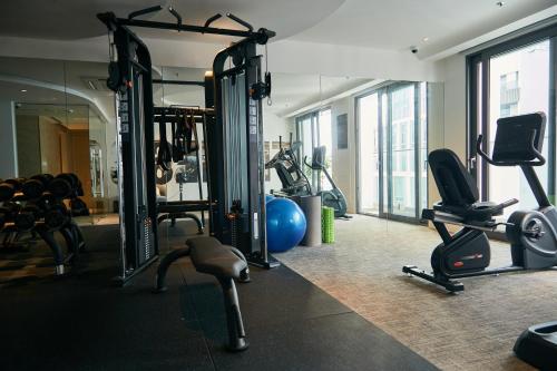 a gym with several treadmills and exercise bikes at Adamas Boutique Hotel Nha Trang in Nha Trang
