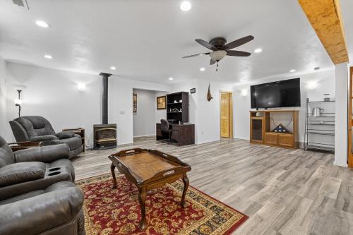 a living room with a couch and a table at Ponderosa Hideaway-ATV, Hiking, Snowmobiling, Hunting & Casino Fun in Deadwood