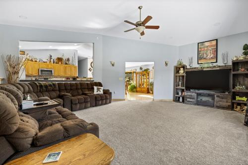 a living room with couches and a flat screen tv at Ponderosa Hideaway-ATV, Hiking, Snowmobiling, Hunting & Casino Fun in Deadwood