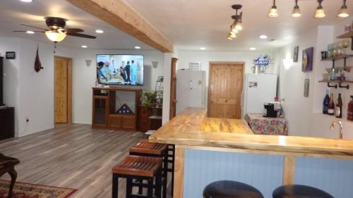 a living room with a bar and a tv at Ponderosa Hideaway-ATV, Hiking, Snowmobiling, Hunting & Casino Fun in Deadwood