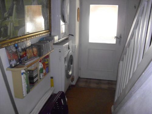 a laundry room with a washing machine and a door at Wannenhof Romantik in Bernau im Schwarzwald