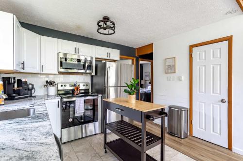 a kitchen with white cabinets and a wooden counter top at Blue Diamond Hot Tub Fire Pit 3 BDR in Tobyhanna