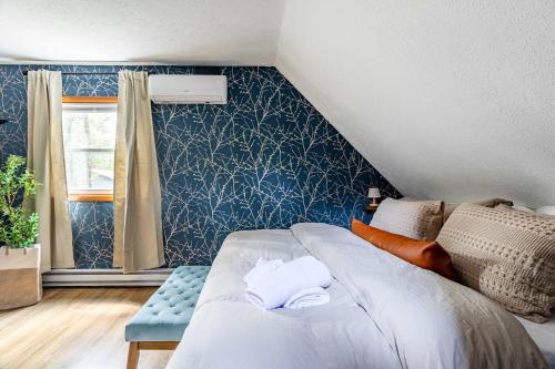a bedroom with a bed with towels on it at Blue Diamond Hot Tub Fire Pit 3 BDR in Tobyhanna