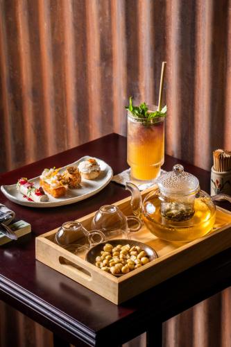 a table with a tray of food and two plates of food at Amanaki Saigon Boutique Hotel in Ho Chi Minh City